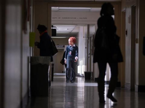 photo of a woman walking down the hallway